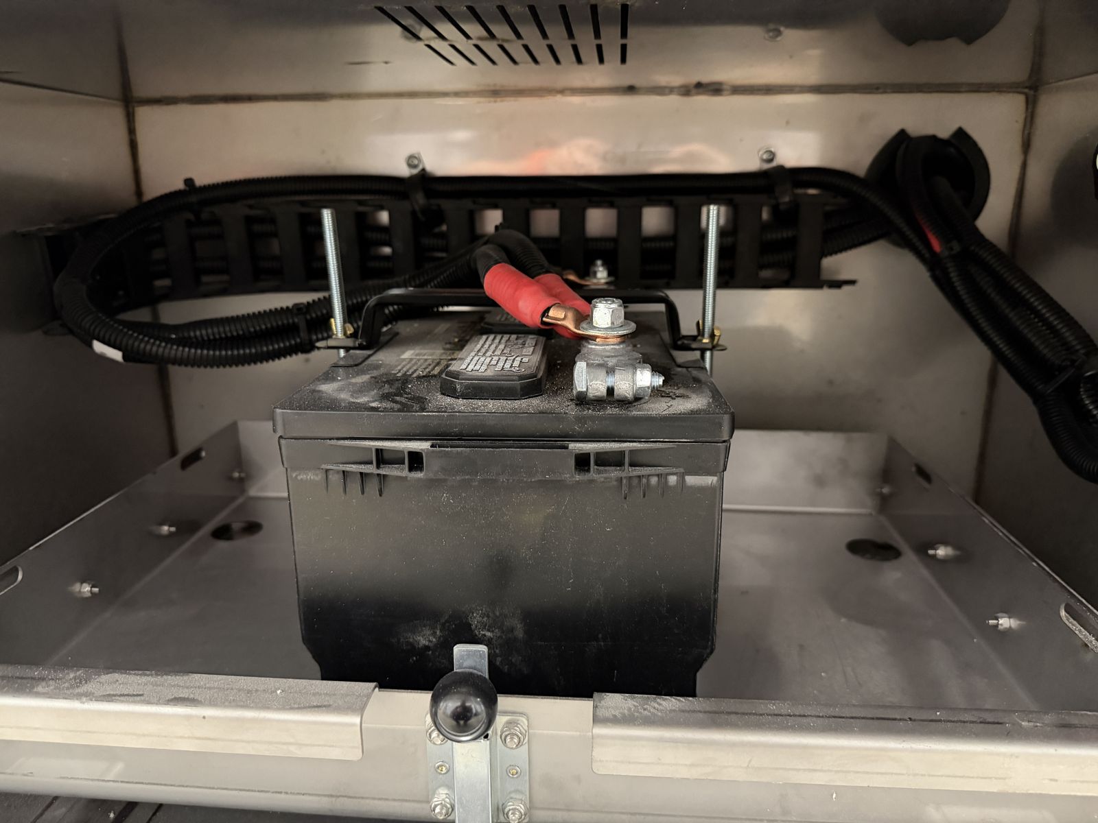 Slide-out battery tray with cable guide