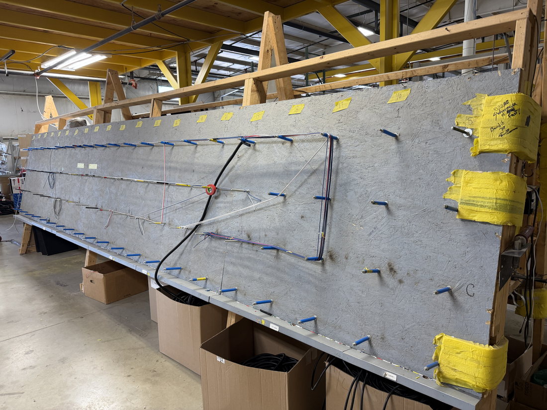 Full-length harness build board in the HLE harness shop