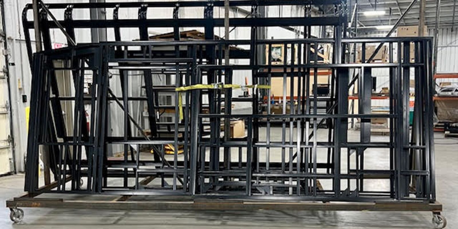 Steel bus components racked for powder coating