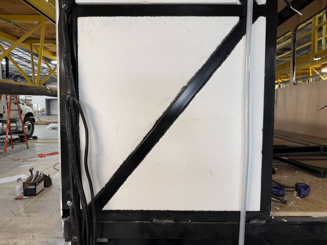 45-degree steel brace welded into the rear wall of an HLE cage, foam already in place
