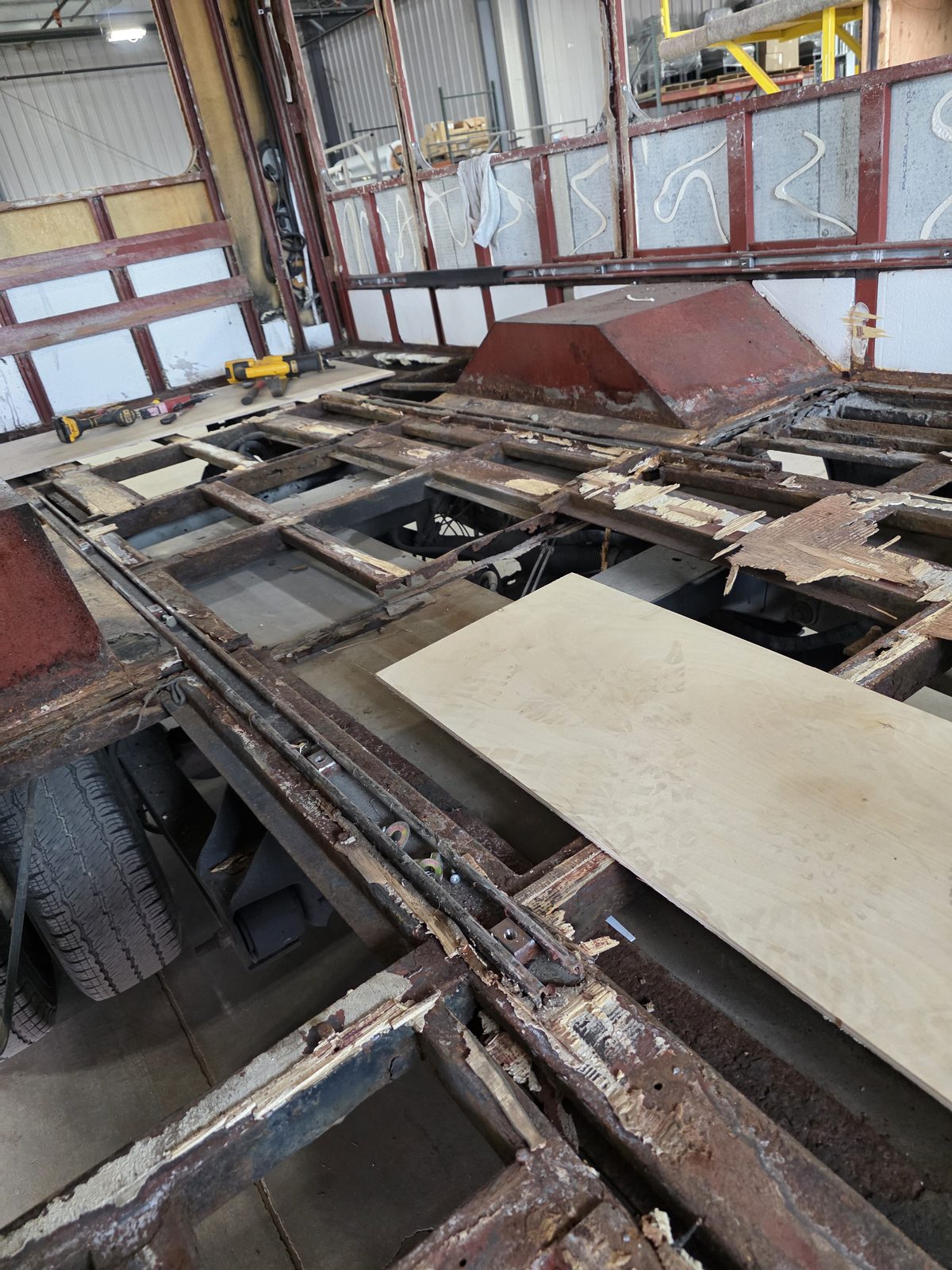 New subfloor panel going onto rebuilt floor structure