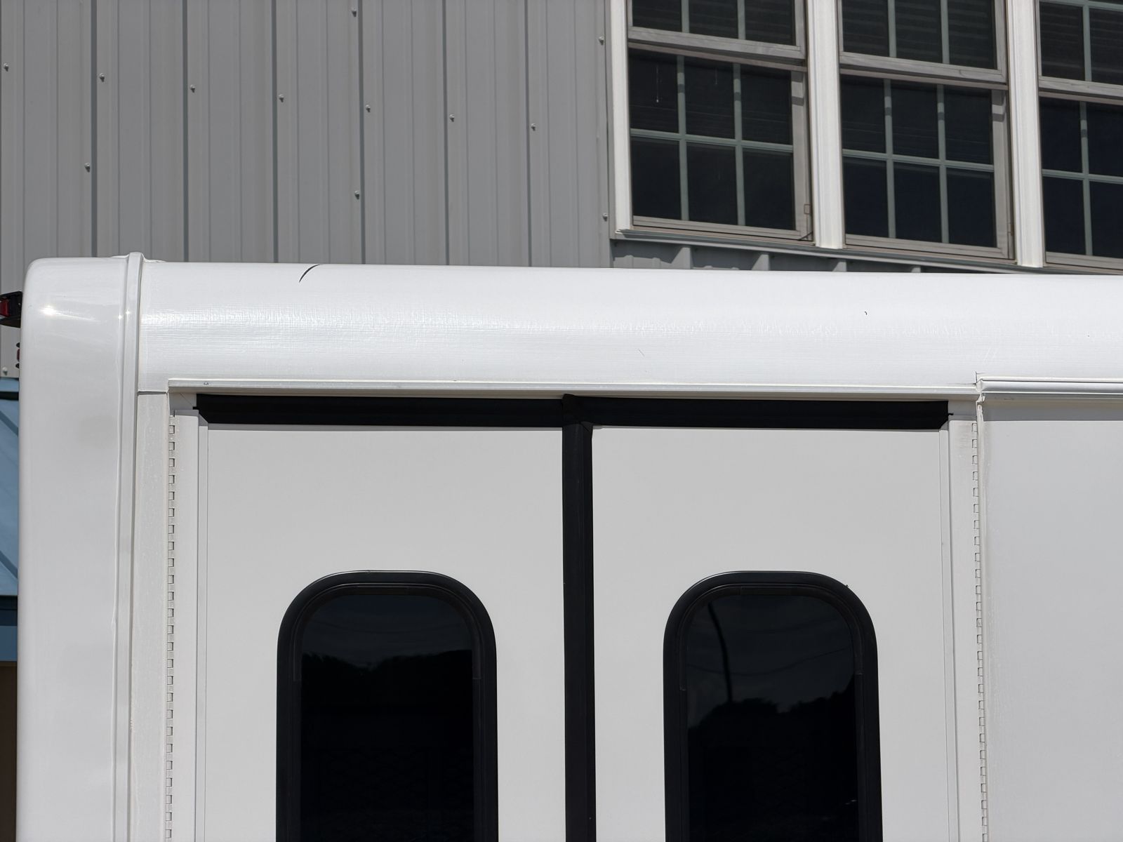 Wheelchair lift door framed below the roof curvature